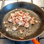 Brown off the bacon | https://theyumyumclub.com/2019/06/24/bavarian-potato-salad-bacon/