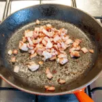 Brown off the bacon | https://theyumyumclub.com/2019/06/24/bavarian-potato-salad-bacon/