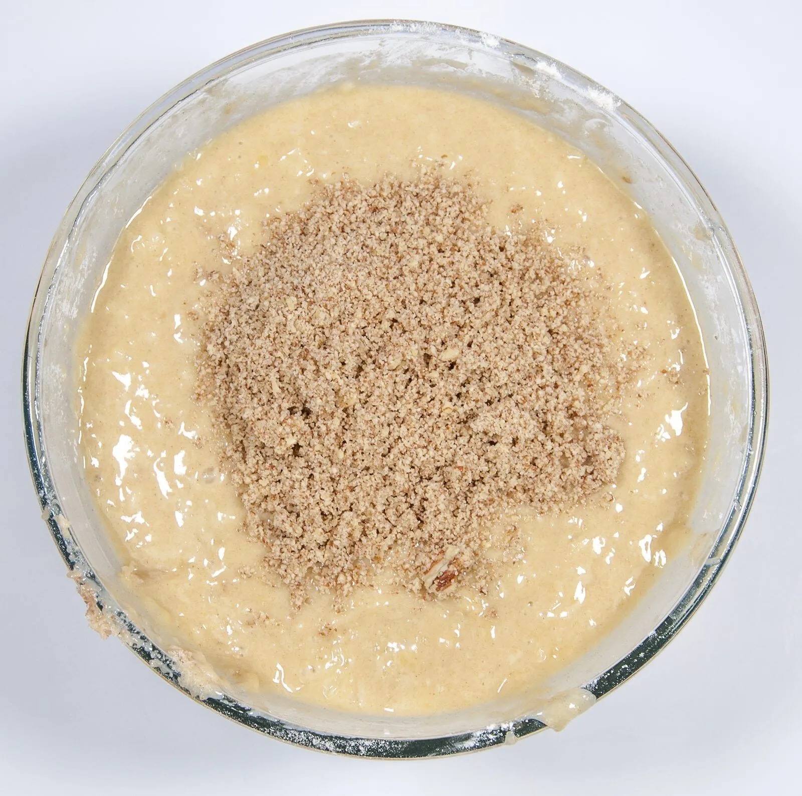 Add the chopped pecans. Humble Hummingbird Cake With Sweet Pecan Dust | https://theyumyumclub.com/2019/06/05/humble-hummingbird-cake-sweet-pecan-dust/
