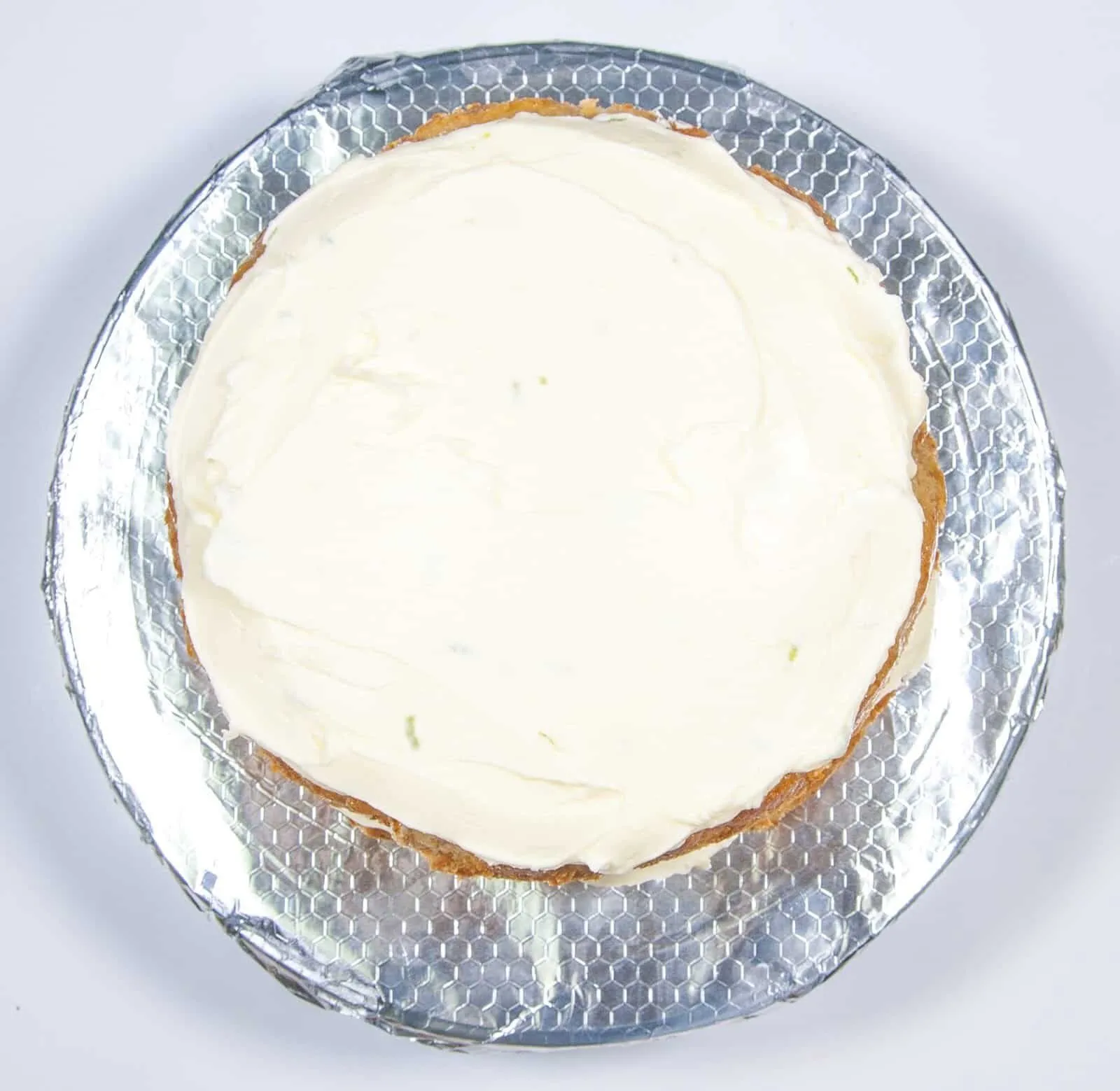 Add the top and cover. Humble Hummingbird Cake With Sweet Pecan Dust | https://theyumyumclub.com/2019/06/05/humble-hummingbird-cake-sweet-pecan-dust/
