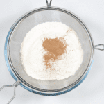 Sieve the flour and cinnamon. Humble Hummingbird Cake With Sweet Pecan Dust | https://theyumyumclub.com/2019/06/05/humble-hummingbird-cake-sweet-pecan-dust/