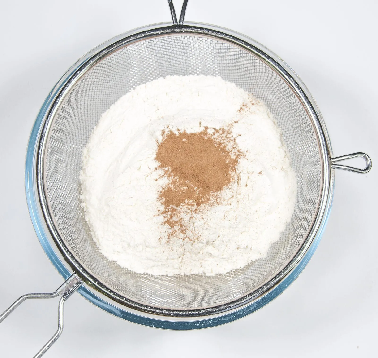 Sieve the flour and cinnamon. Humble Hummingbird Cake With Sweet Pecan Dust | https://theyumyumclub.com/2019/06/05/humble-hummingbird-cake-sweet-pecan-dust/