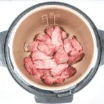 Add the beef to the slow cooker | https://theyumyumclub.com/2019/06/27/sriracha-beef-gangnam-style/