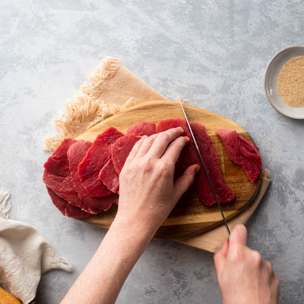 Cut the steak in long stripes.