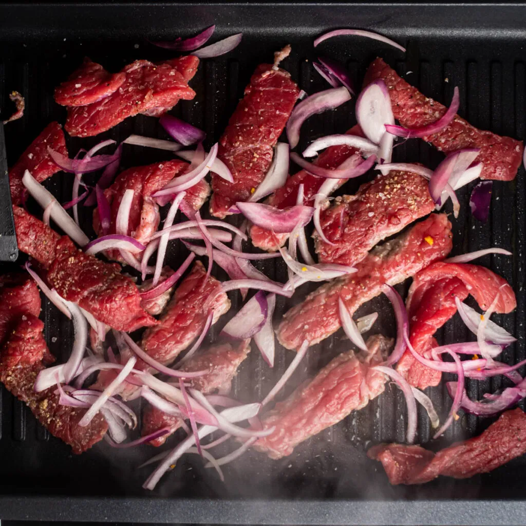 add the red onion and steak stripes.