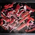 add the red onion and steak stripes.